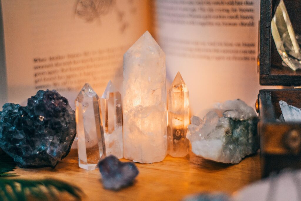 Close-up of various divine healing crystals on a wooden table with warm lighting
